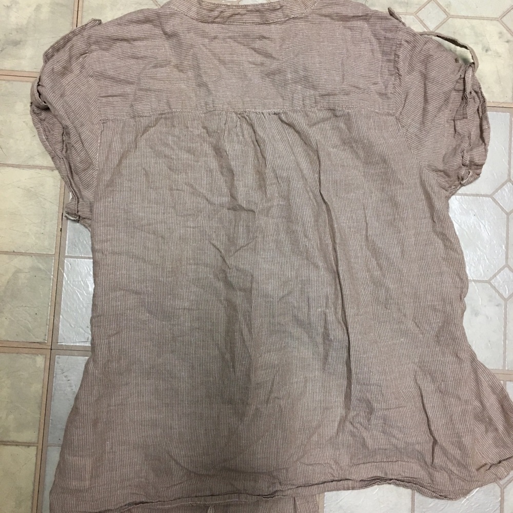 Light brown button in front, tie in back blouse.
